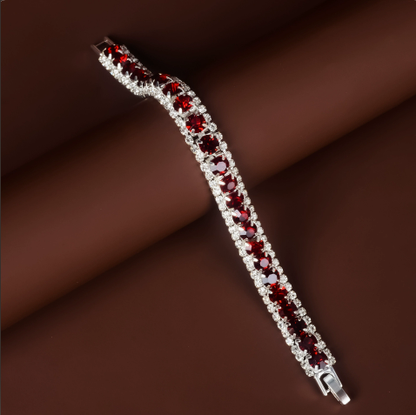 Silver-tone tennis bracelet with dark red rectangular stones and clear stone borders.