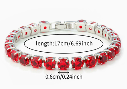 Silver-tone tennis bracelet with round faceted red stones and a rectangular clasp.