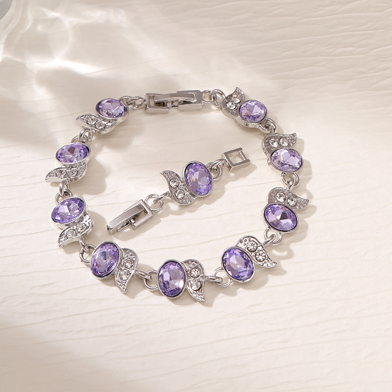 Silver-tone bracelet with purple oval stones, clear leaf accents and a clasp.