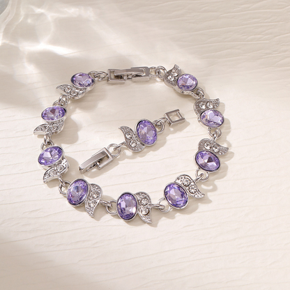 Silver-tone bracelet with purple oval stones, clear leaf accents and a clasp.