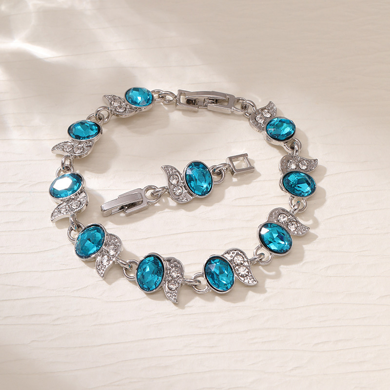 Silver-tone bracelet with light blue oval stones, clear leaf accents and a clasp.