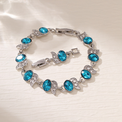 Silver-tone bracelet with light blue oval stones, clear leaf accents and a clasp.