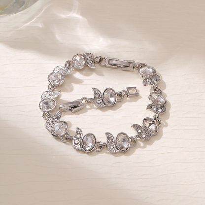 Silver-tone bracelet with clear oval stones, clear leaf accents and a clasp.