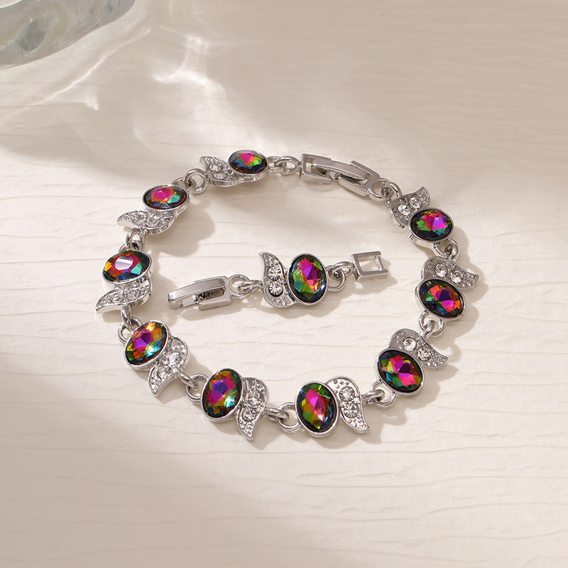 Silver-tone bracelet with rainbow oval stones, clear leaf accents and a clasp.
