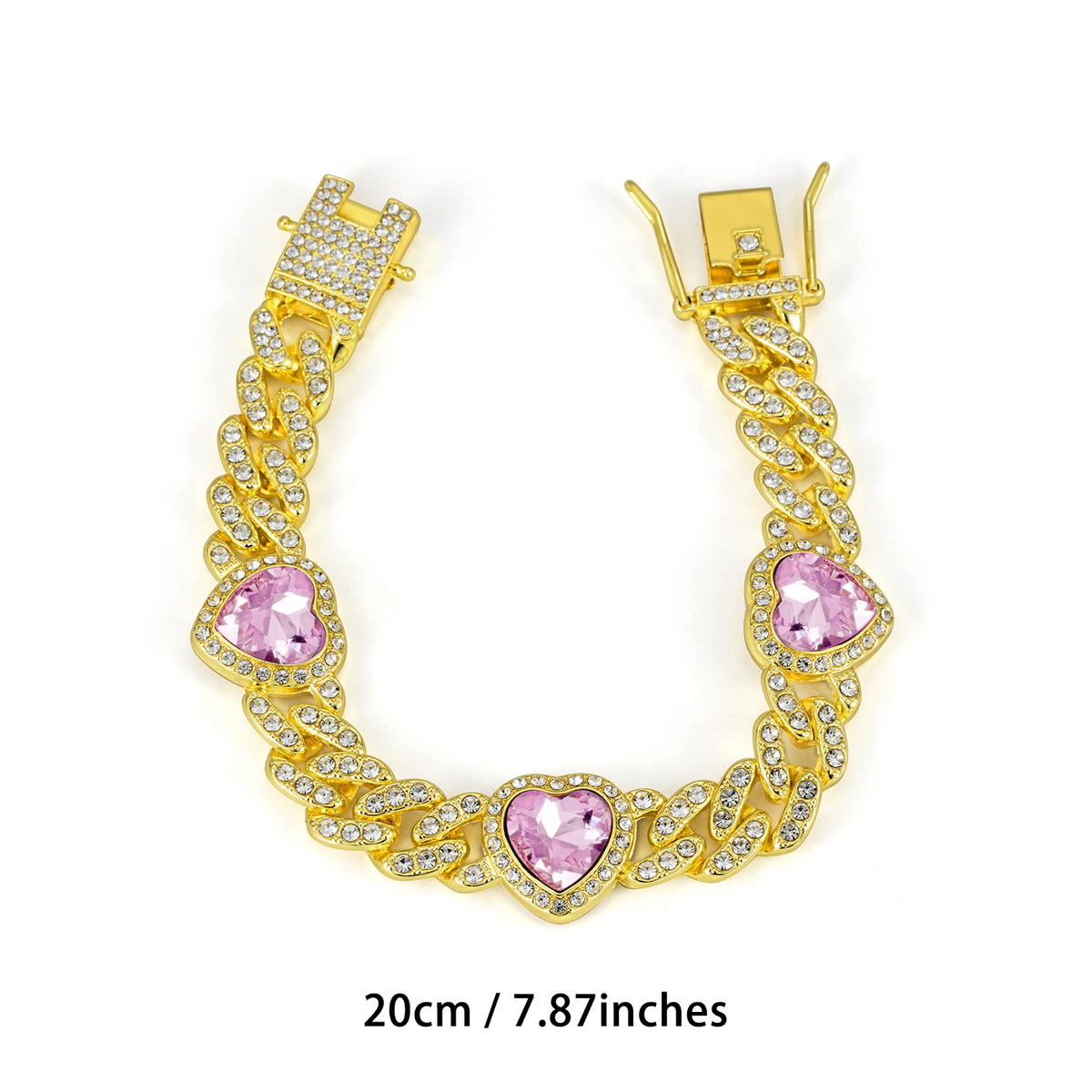 Gold Tone Cuban link bracelet with three pink heart-shaped accents and a clasp; 20 cm.