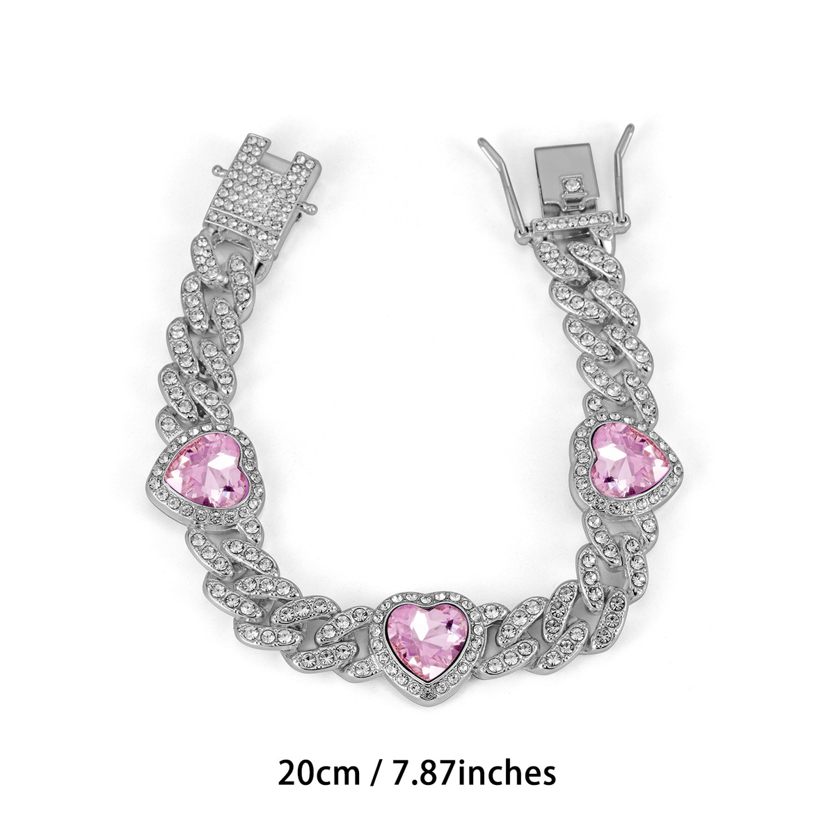 Silver Tone Cuban link bracelet with three pink heart-shaped accents and a clasp; 20 cm.