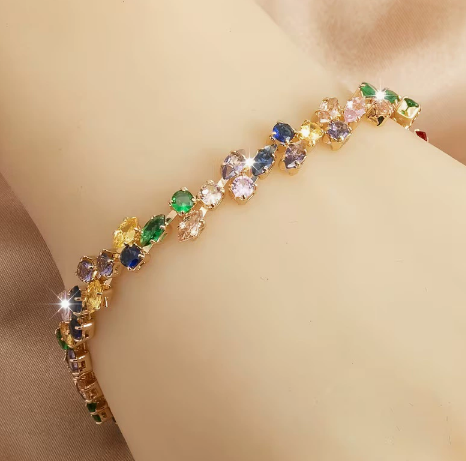 Gold-tone bracelet with multicolor marquise-shaped stones and round clear accents in a leaf-like pattern.