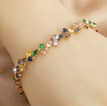 Gold-tone bracelet with multicolor marquise-shaped stones and round clear accents in a leaf-like pattern.