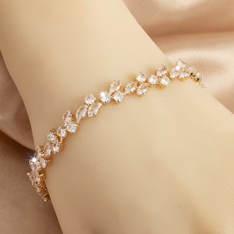 Gold-tone bracelet with clear marquise-shaped stones and round clear accents in a leaf-like pattern.