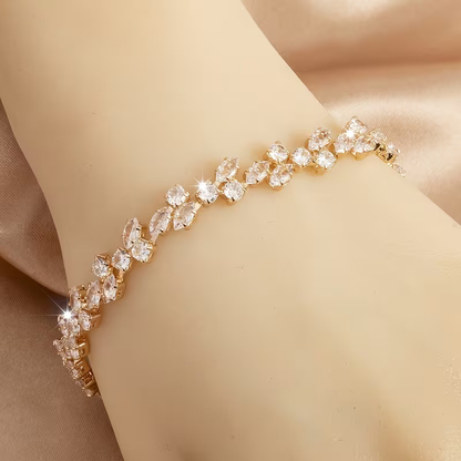 Gold-tone bracelet with clear marquise-shaped stones and round clear accents in a leaf-like pattern.