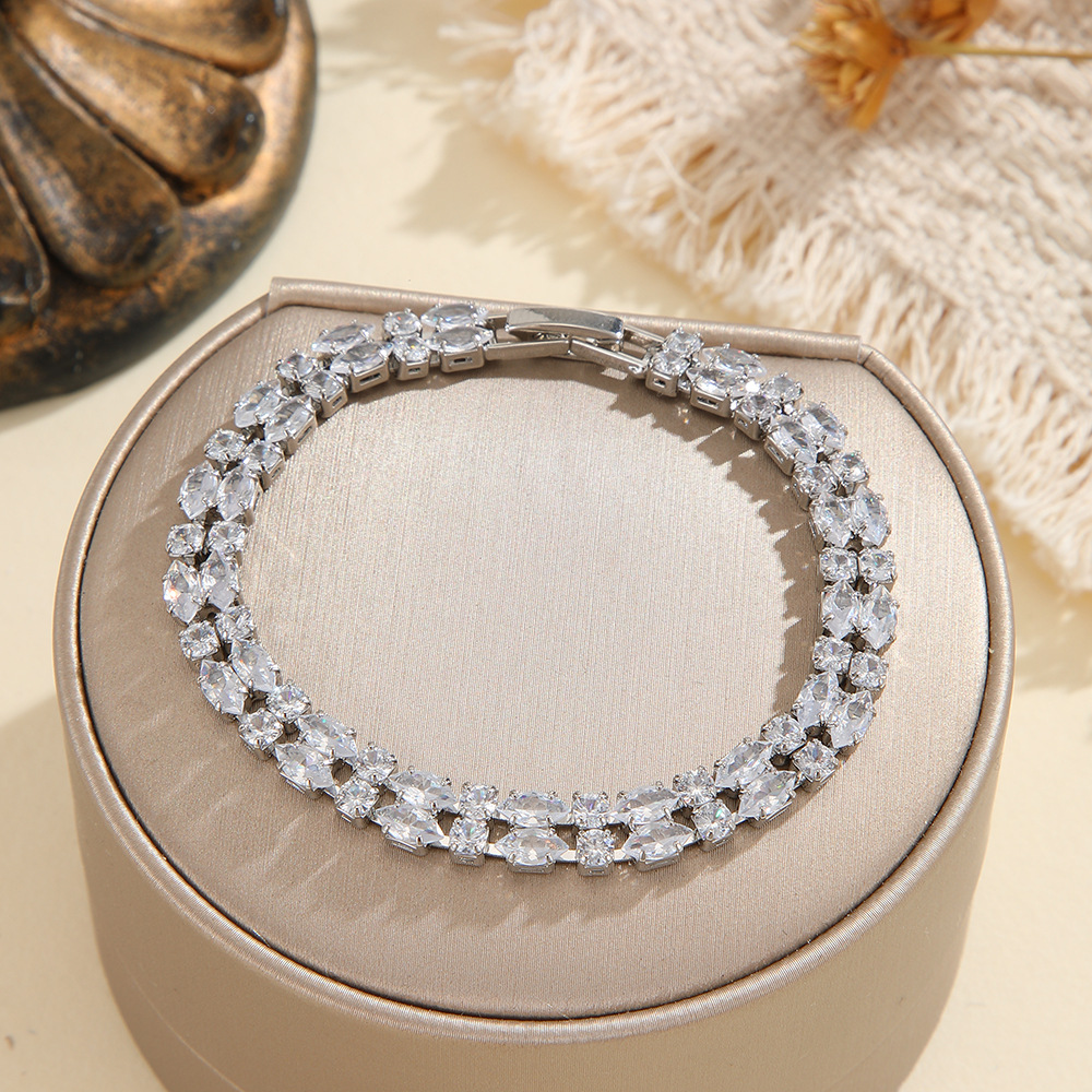 Silver-tone double-row bracelet in clear with paired marquise-shaped stones and small round accents.