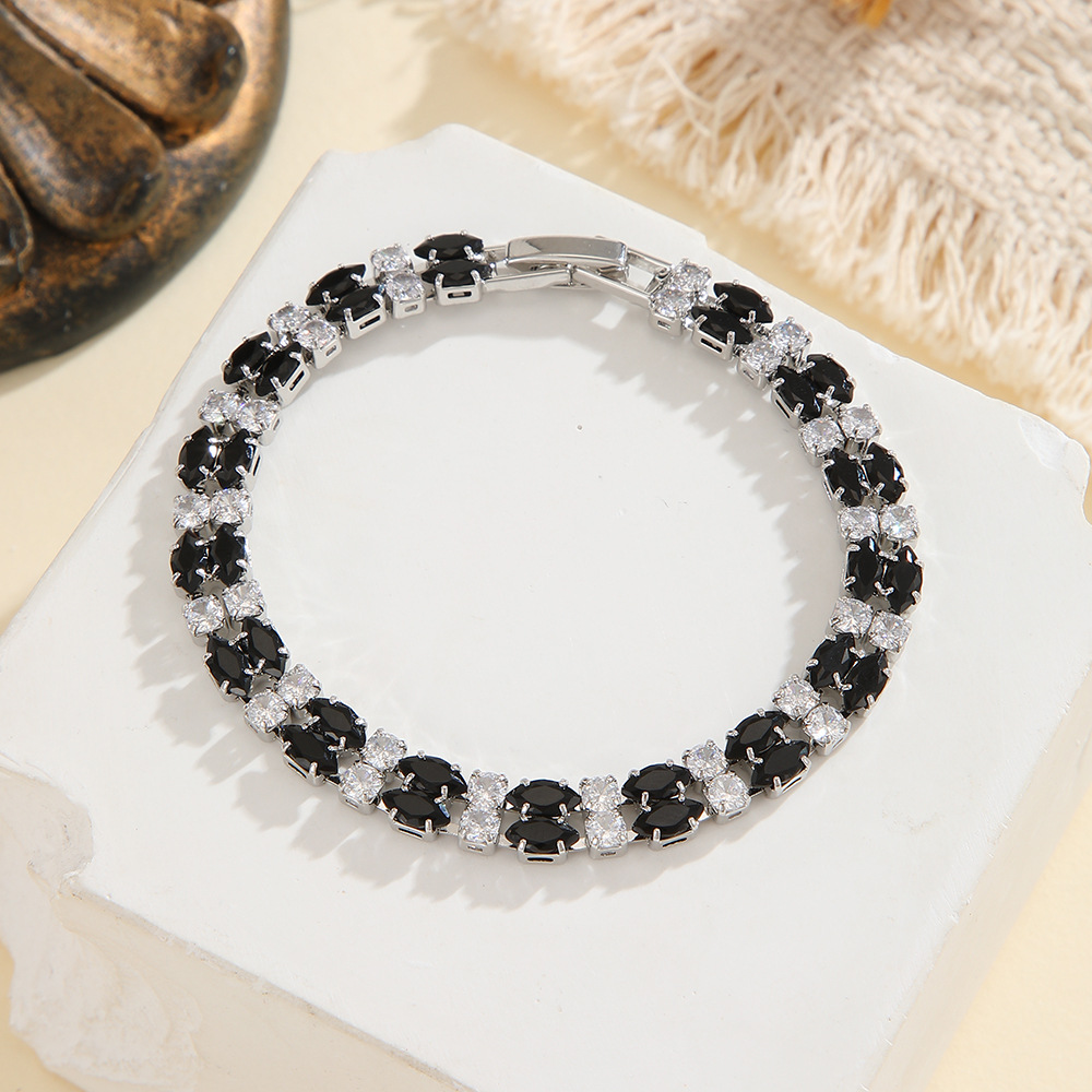 Silver-tone double-row bracelet in clear / black with paired marquise-shaped stones and small round accents.