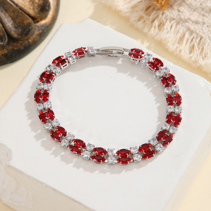 Silver-tone double-row bracelet in clear / red with paired marquise-shaped stones and small round accents.
