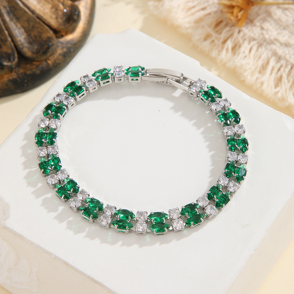 Silver-tone double-row bracelet in clear / green with paired marquise-shaped stones and small round accents.