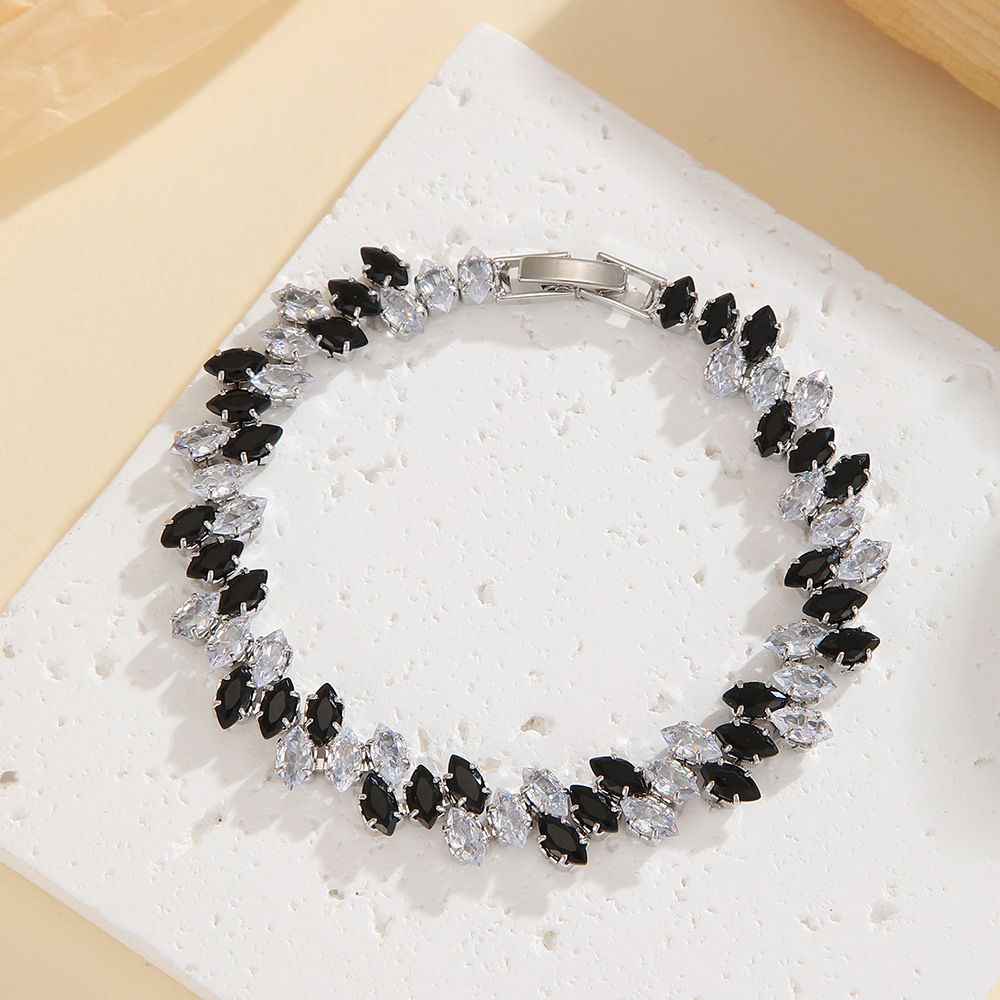 Silver-tone leaf-wreath bracelet in clear / black with angled marquise-shaped stones and a clasp.