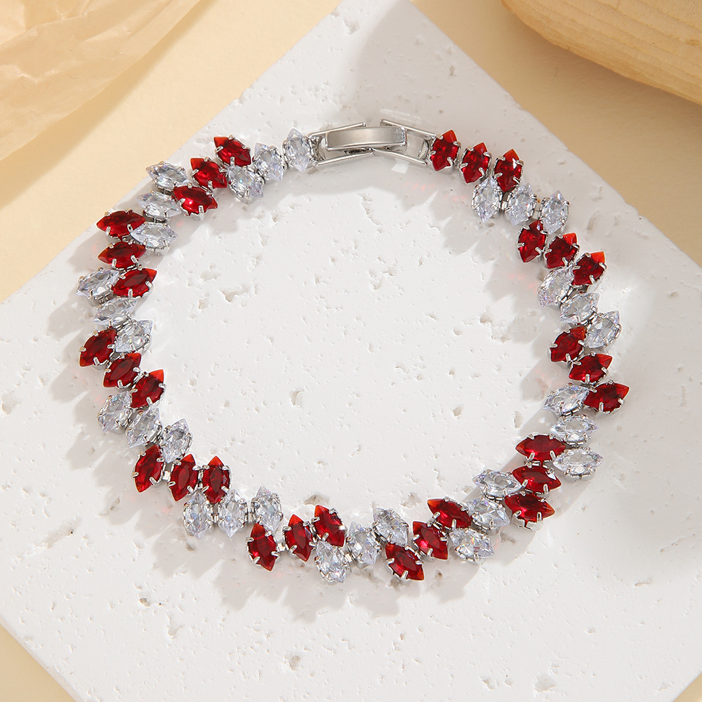 Silver-tone leaf-wreath bracelet in clear / red with angled marquise-shaped stones and a clasp.