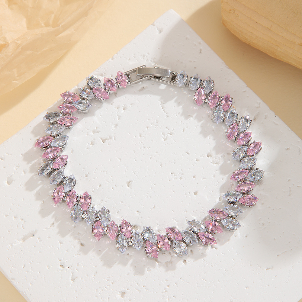 Silver-tone leaf-wreath bracelet in clear / pink with angled marquise-shaped stones and a clasp.