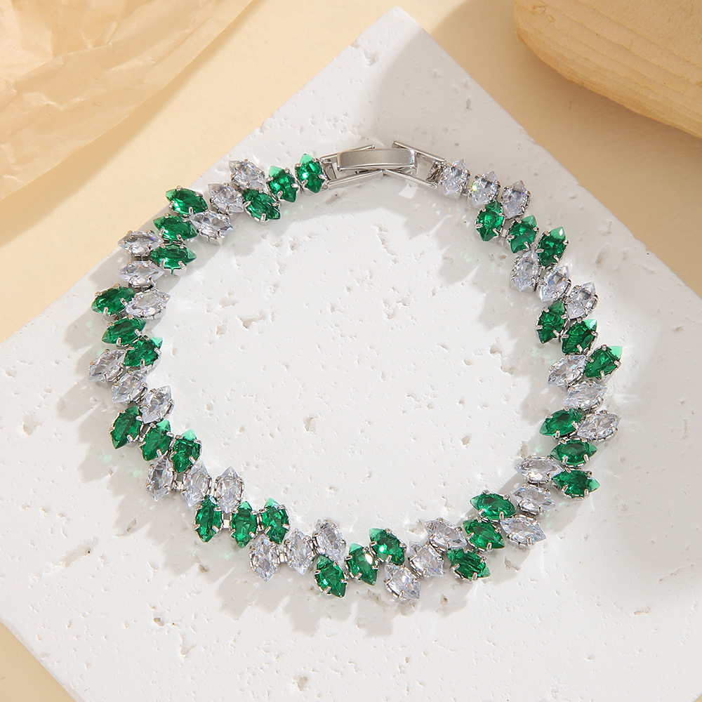 Silver-tone leaf-wreath bracelet in clear / green with angled marquise-shaped stones and a clasp.