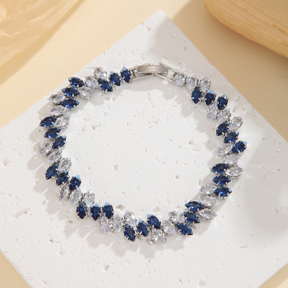 Silver-tone leaf-wreath bracelet in clear / blue with angled marquise-shaped stones and a clasp.