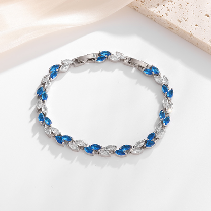 Silver-tone petite leaf bracelet with blue stone accents and a clasp.
