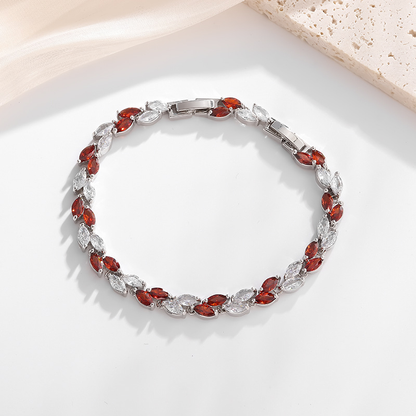 Silver-tone petite leaf bracelet with red stone accents and a clasp.