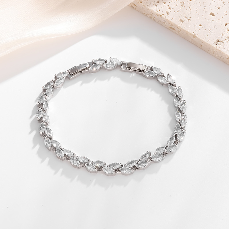 Silver-tone petite leaf bracelet with clear stone accents and a clasp.