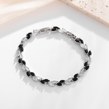 Silver-tone petite leaf bracelet with black stone accents and a clasp.