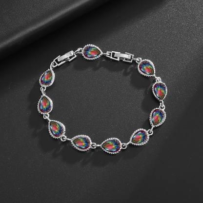 Silver-tone bracelet with iridescent rainbow teardrop center stones, clear halo accents and a clasp.