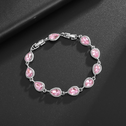 Silver-tone bracelet with pink teardrop center stones, clear halo accents and a clasp.
