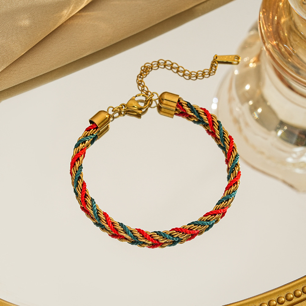 Braided bracelet in red / green / gold tone with gold-tone end caps, a lobster clasp and extension chain.