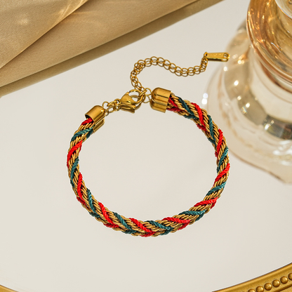 Braided bracelet in red / green / gold tone with gold-tone end caps, a lobster clasp and extension chain.