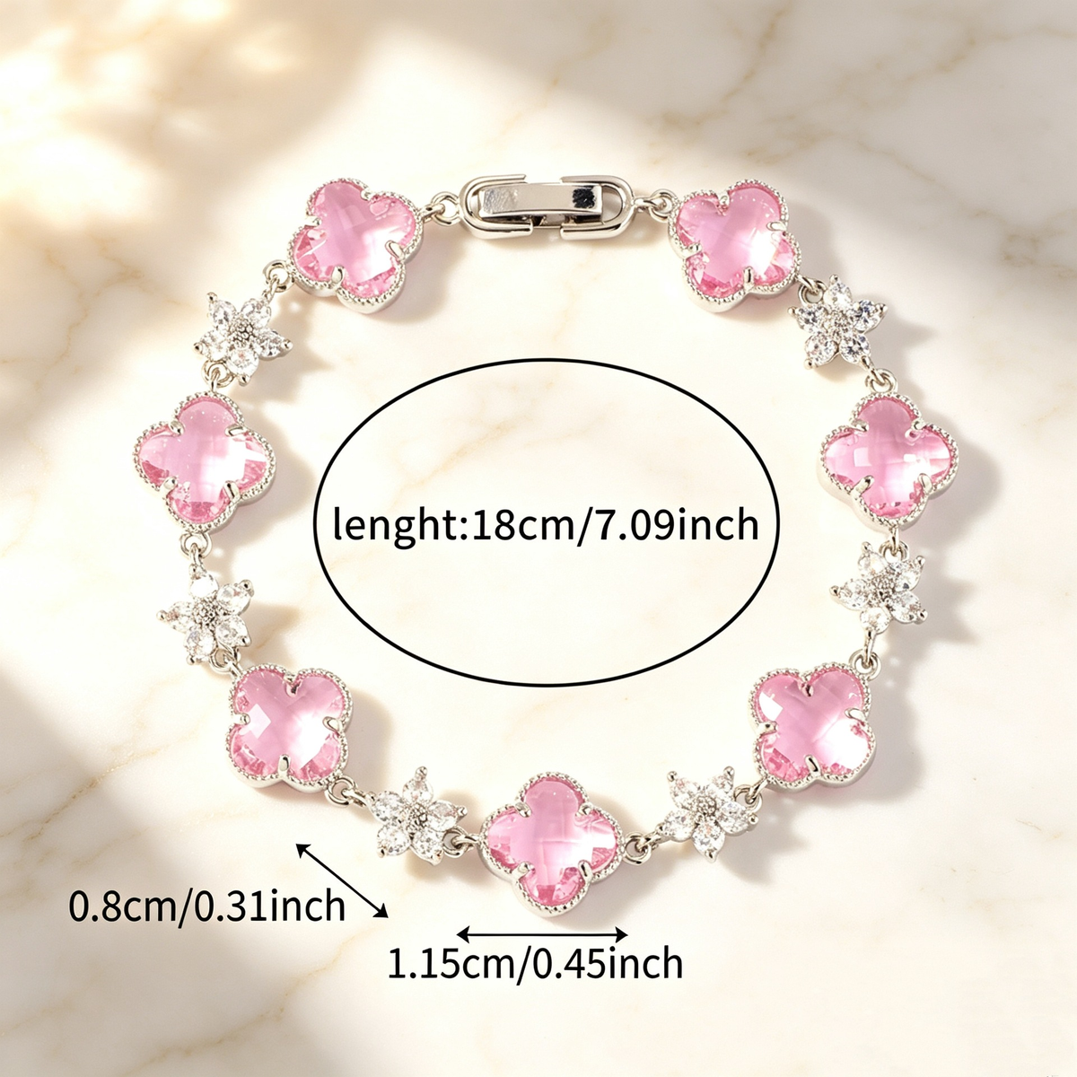 Silver Tone bracelet with pink four-leaf clovers and small clear flower links; length 18 cm.