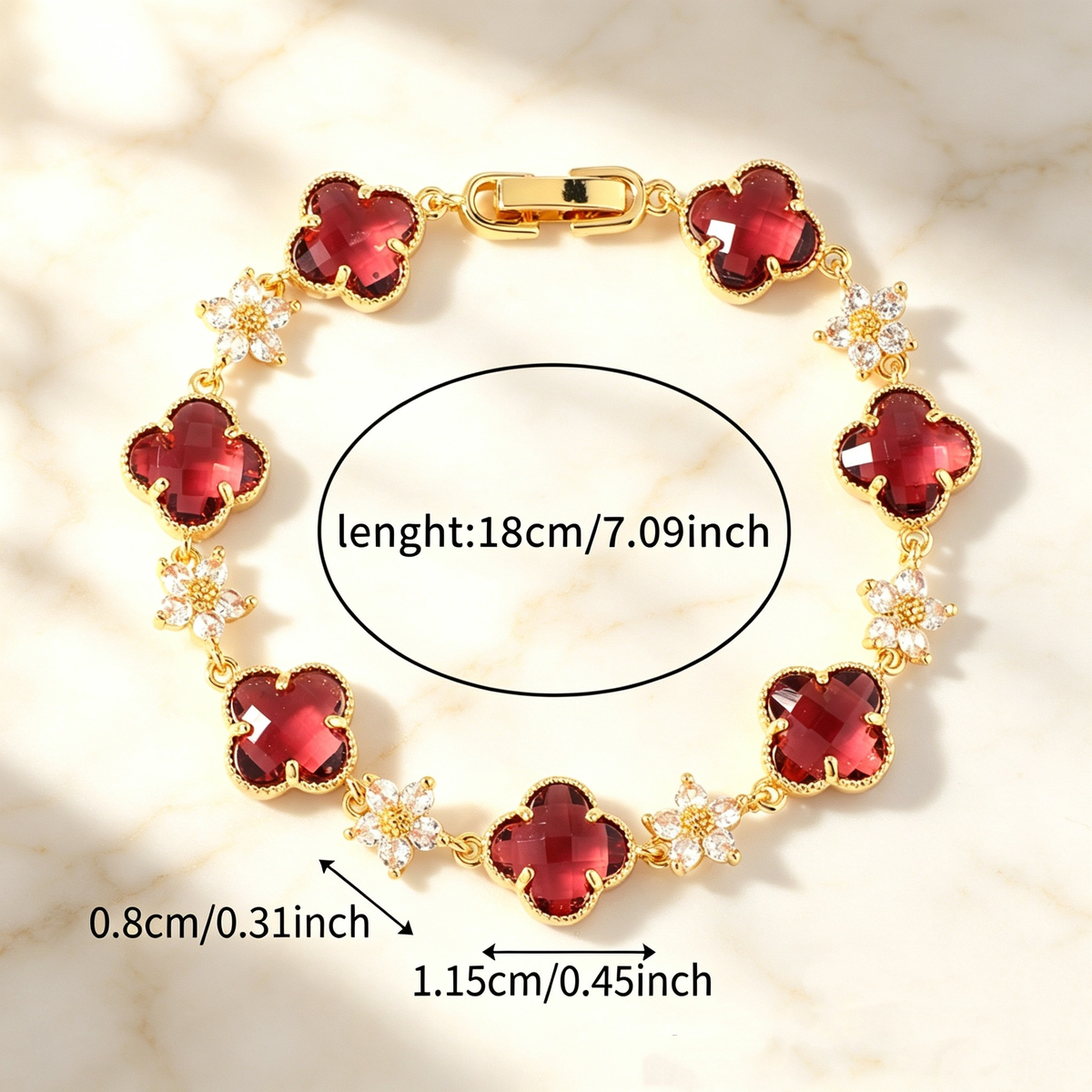 Gold Tone bracelet with deep warm-colored four-leaf clovers and small clear flower links; length 18 cm.