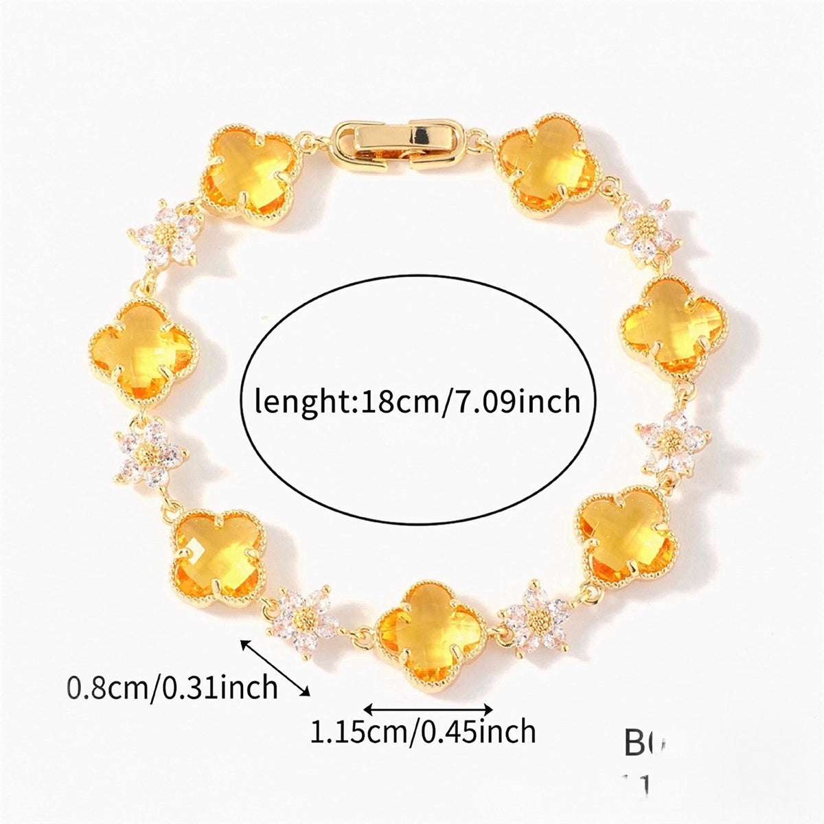 Gold Tone bracelet with yellow four-leaf clovers and small clear flower links; length 18 cm.