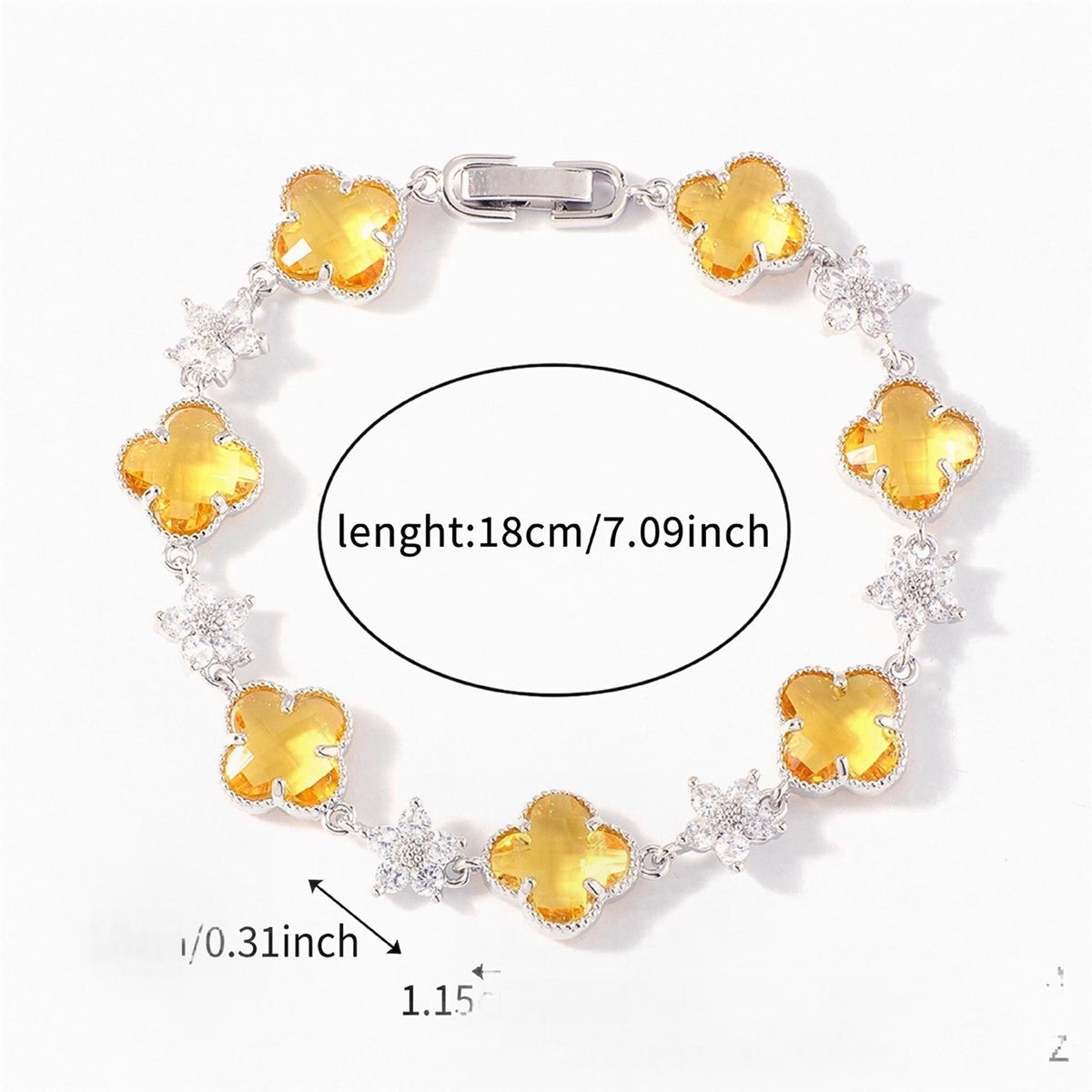 Silver Tone bracelet with yellow four-leaf clovers and small clear flower links; length 18 cm.