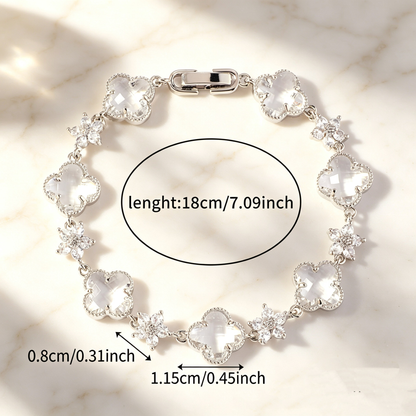 Silver Tone bracelet with clear four-leaf clovers and small clear flower links; length 18 cm.