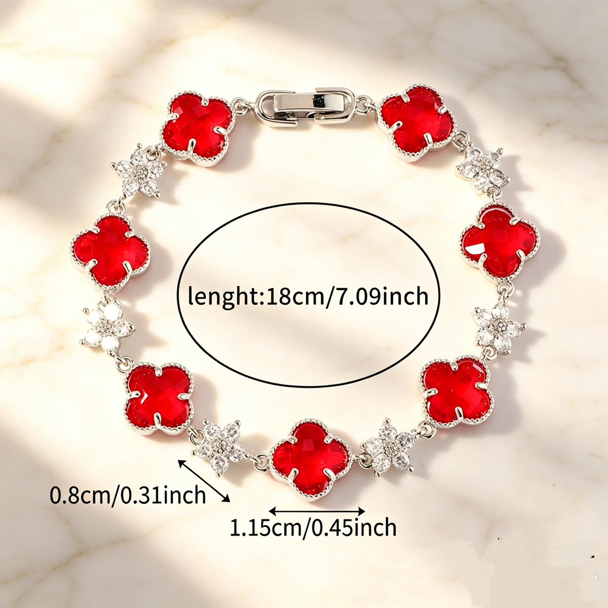 Silver Tone bracelet with red four-leaf clovers and small clear flower links; length 18 cm.