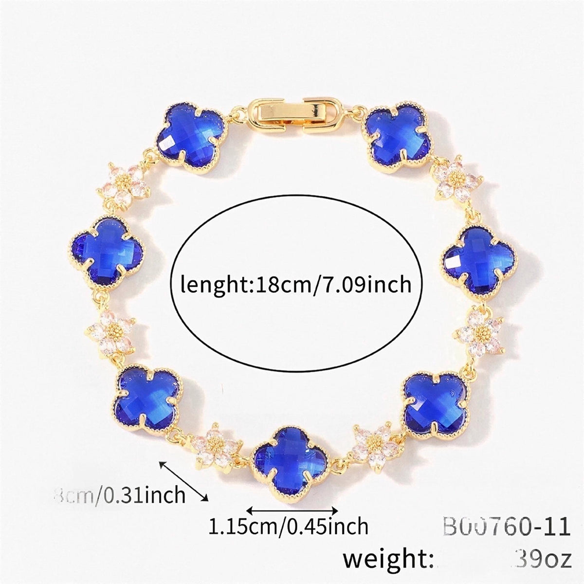 Gold Tone bracelet with blue four-leaf clovers and small clear flower links; length 18 cm.
