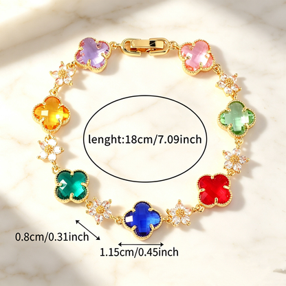 Gold Tone bracelet with multicolor four-leaf clovers and small clear flower links; length 18 cm.