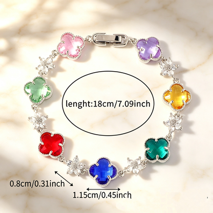 Silver Tone bracelet with multicolor four-leaf clovers and small clear flower links; length 18 cm.