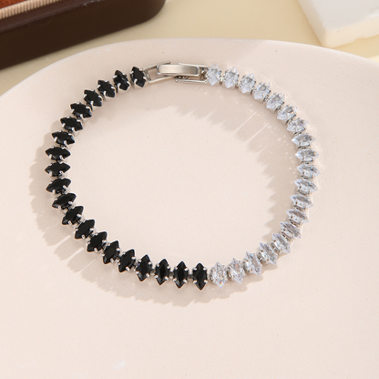 Silver-tone bracelet with separate clear / black sections of marquise-shaped stones and a clasp.