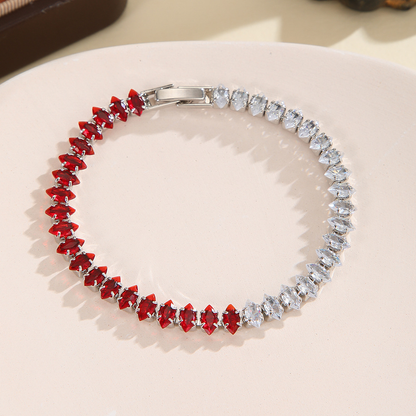 Silver-tone bracelet with separate clear / red sections of marquise-shaped stones and a clasp.
