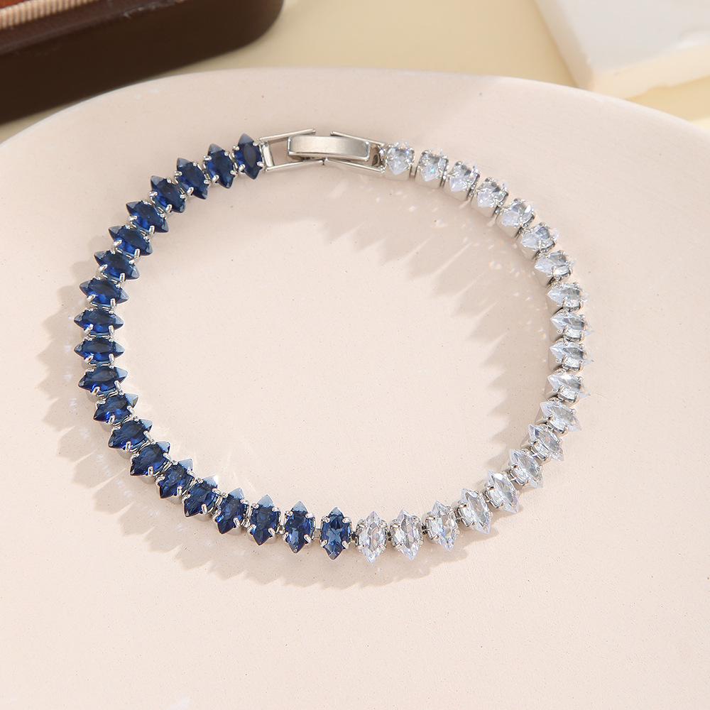 Silver-tone bracelet with separate clear / blue sections of marquise-shaped stones and a clasp.