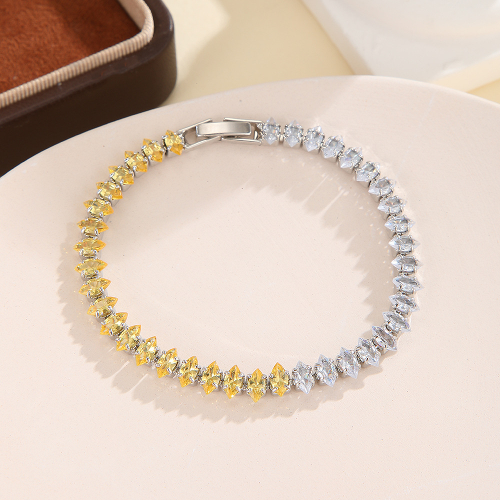 Silver-tone bracelet with separate clear / golden yellow sections of marquise-shaped stones and a clasp.