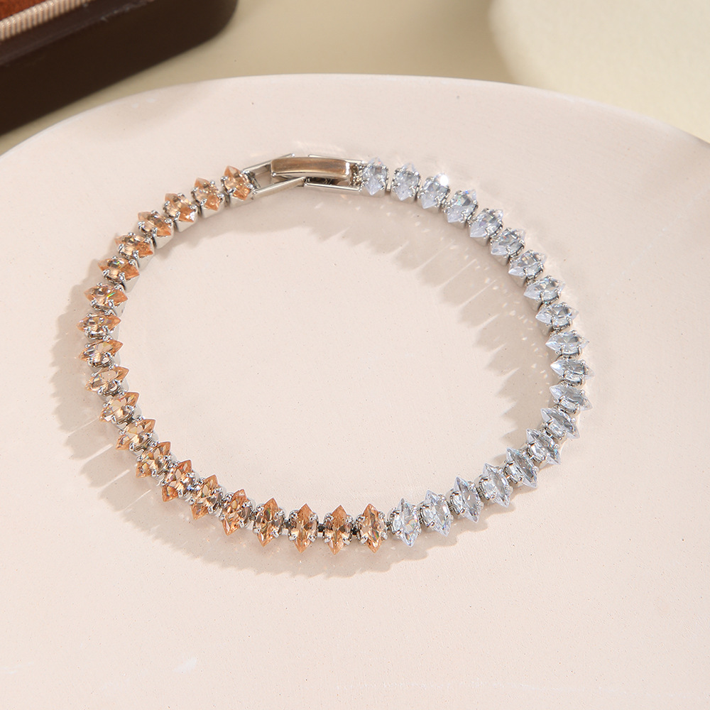 Silver-tone bracelet with separate clear / champagne sections of marquise-shaped stones and a clasp.