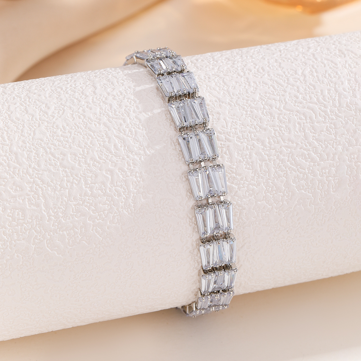 Silver-tone bracelet with three-stone geometric panels in the clear arrangement.