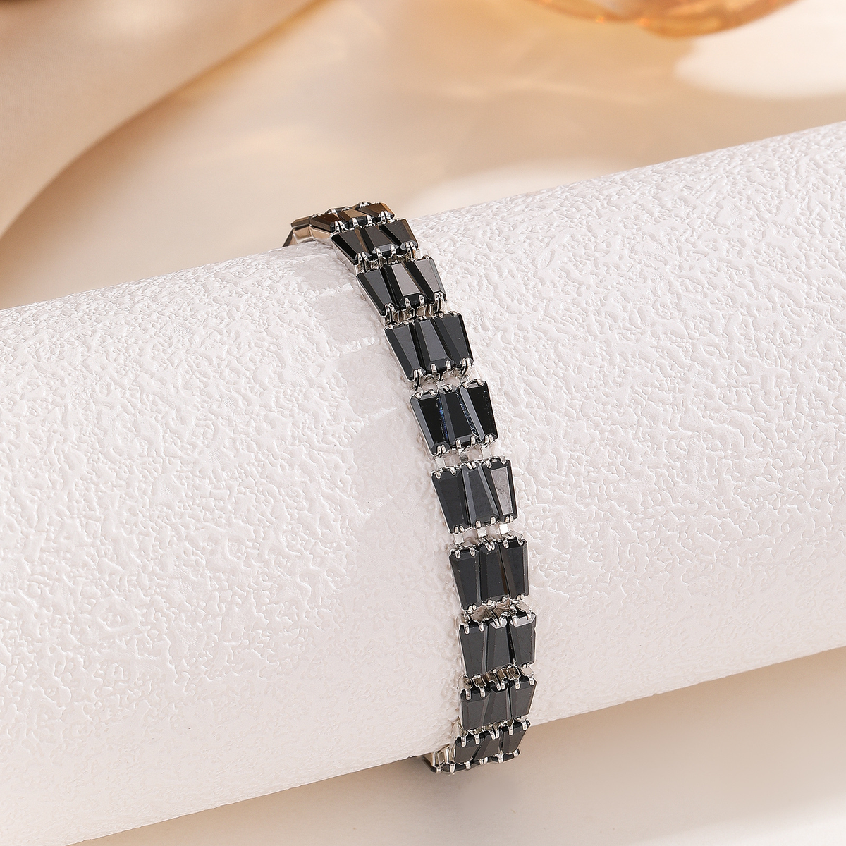 Silver-tone bracelet with three-stone geometric panels in the black arrangement.