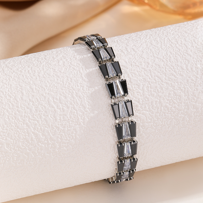 Silver-tone bracelet with three-stone geometric panels in the clear center / black sides arrangement.