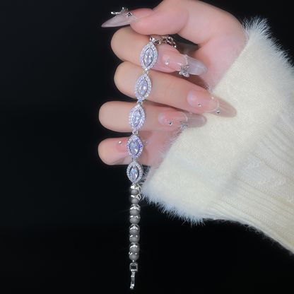 Silver-tone bracelet with pointed oval center motifs, clear halo accents and rounded chain links.