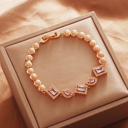 Gold Tone bracelet, style TSL004, with rectangular and teardrop halo centers with rounded links and a clasp.